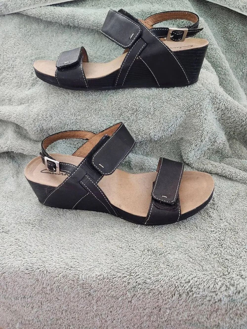 Clarks Alto Disco Wedge Sandal in black leather. It is a classic comfort-driven